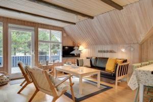 a living room with a couch and a table at Søndervang 4 in Nørre Nebel
