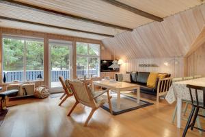 a living room with a table and a couch at Søndervang 4 in Nørre Nebel
