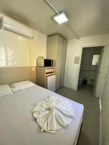 a bedroom with a bed with a towel on it at Pousada Fornerolli in Penha