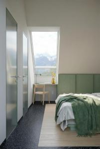 a bedroom with a bed and a large window at Vila Soča in Bovec