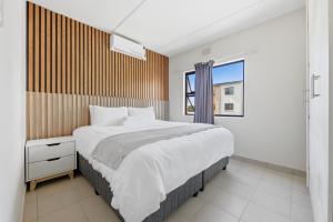 a bedroom with a large bed and a window at Gae La Rona in Gaphatshwe +19 photos