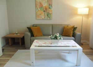 a living room with a couch and a coffee table at Apartment Schlossblick - Top location in Idar-Oberstein