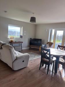 a living room with a couch and a table at Moate View Lodge in Ballymore Eustace