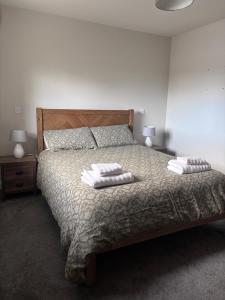 a bedroom with a bed with two pillows on it at Moate View Lodge in Ballymore Eustace