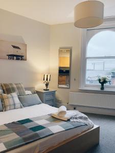 a bedroom with a bed with a hat on it at Beds at 46, Cowes in Cowes
