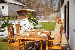 a wooden table and chairs on a patio at Alpenpanorama Bad Kohlgrub in Bad Kohlgrub