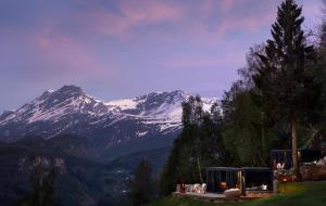 a house with a view of a snow covered mountain at Kilsti Lodge in Eidsdal