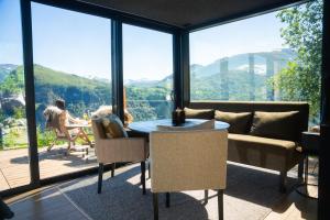 a living room with a couch and a table at Kilsti Lodge in Eidsdal +7 photos