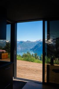 a room with a sliding glass door looking out at a view at Kilsti Lodge in Eidsdal