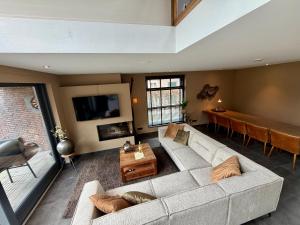 a living room with a couch and a table at Thuysgrond in Bergeijk