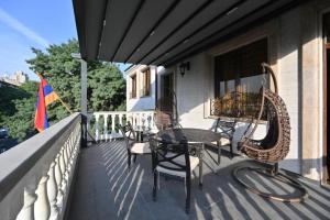 a patio with chairs and a table on a balcony at Partez Hotel in Yerevan