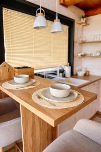 a kitchen with two bowls on a wooden table at BeLaWood in Egerszalók