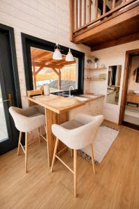 a kitchen with a wooden table and two chairs at BeLaWood in Egerszalók