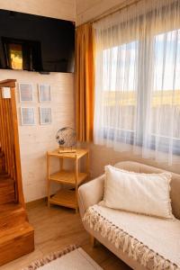 a living room with a couch and a window at BeLaWood in Egerszalók +32 photos