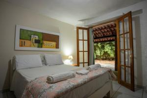 a bedroom with a large bed and a window at Pousada Campina do Monte Alegre in Campina do Monte Alegre