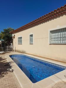 a swimming pool in front of a house at MEDDAYS Villa BERLÍN in Miami Platja