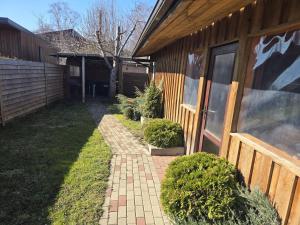 a house with a brick walkway next to a building at Kotedža Tīkli in Bigauņciems