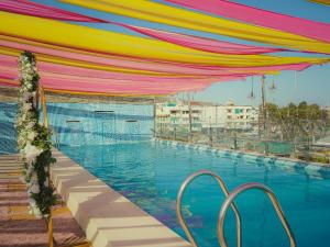 a pool with a colorful canopy over a swimming pool at THE GRAND SUNCITY HOTEL AND RESORT, Bhopal in Bhopal