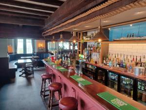 a bar with bar stools in a restaurant at The Paris Hotel in Coverack