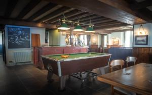a billiard room with a pool table in a restaurant at The Paris Hotel in Coverack
