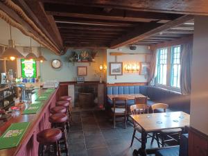 a bar with wooden tables and chairs in a restaurant at The Paris Hotel in Coverack +23 photos