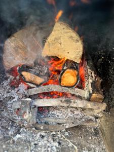 a fire is burning in a fire pit at The Niblet Bonnie View Glamping Cabins, Helmsley in Carlton