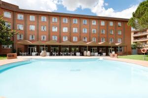 a large swimming pool in front of a building at Hotel SB Corona Tortosa in Tortosa