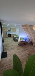a living room with a staircase and a dining room at L'Escale Chaunoise in Chauny
