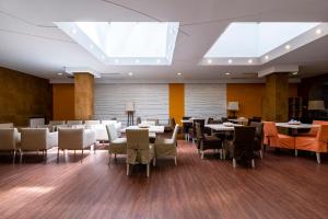 a dining room with tables and chairs and a skylight at Star Hotel by Mellow Mood Hotels in Budapest