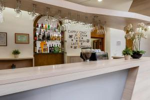 a bar with a counter with a lot of bottles at Star Hotel by Mellow Mood Hotels in Budapest