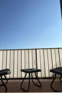 two tables with wine glasses sitting on a balcony at Garda Green - Luxury Apartment in Lonato