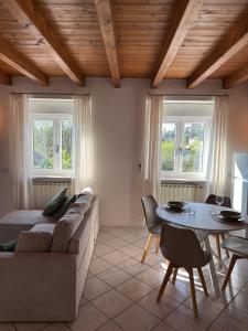 a living room with a couch and a table at Garda Green - Luxury Apartment in Lonato