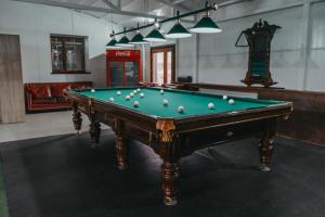a pool table with balls on it in a room at KokTau in Kokshetau