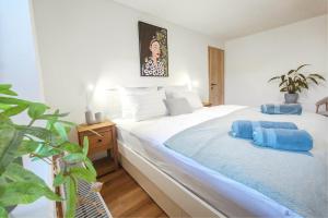 a bedroom with two beds with blue towels on them at Red Maple Apartments in Maribor