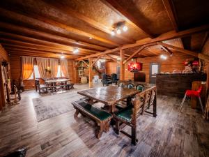 a large room with a wooden table and a piano at KokTau in Kokshetau +15 photos