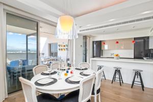a kitchen and dining room with a white table and chairs at City Penthouse in Larnaca