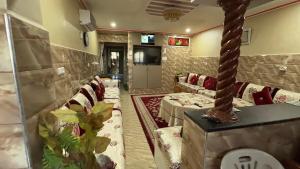a room with couches and a tv in a room at Imi Ouaddar Sea View Retreat in Agadir +1 photo