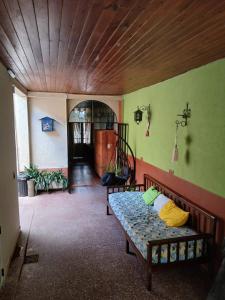 a room with a bed and a wooden ceiling at El Balcón de la Tata Hostel in San Salvador de Jujuy