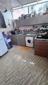 a kitchen with a stove and a washing machine at Imi Ouaddar Sea View Retreat in Agadir