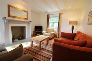a living room with a couch and a table at 3 Bed in Gower oc-hh472 in Cheriton