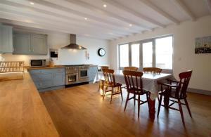 a kitchen with a table and chairs in a room at 3 Bed in Gower oc-hh472 in Cheriton