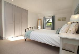 a bedroom with a large white bed and a window at 3 Bed in Gower oc-hh472 in Cheriton