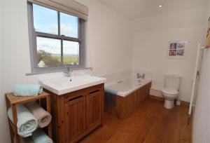 a bathroom with a sink and a tub and a toilet at 3 Bed in Gower oc-hh472 in Cheriton +16 photos