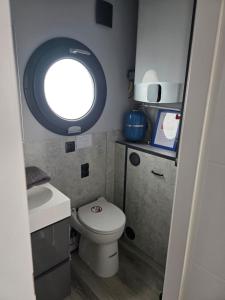 a small bathroom with a toilet and a window at Fjord Lyckholm in Schleswig