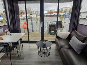 a living room with a couch and a table at Fjord Lyckholm in Schleswig