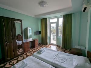 a bedroom with a large bed and a mirror at Panorama hotel kobuleti in Kobuleti +182 photos
