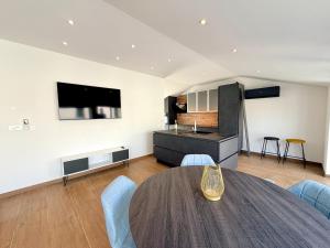a living room with a table and a kitchen at Apartment Lasta Medulin in Medulin