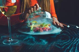 a person sitting at a table with a plate of food at Leonardo Hotel Papendrecht in Papendrecht