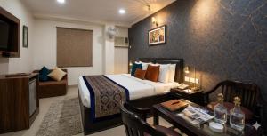 a hotel room with a bed and a living room at HOTEL DAKHA INTERNATIONAL - Karol Bagh, New Delhi in New Delhi
