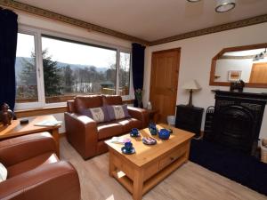 a living room with a couch and a fireplace at 3 Bed in Inverness oc-in633 in Balnain